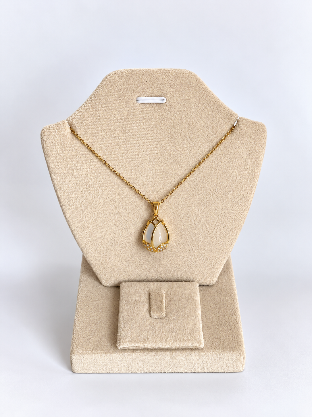 Gold Pendant on Beige Velvet Display